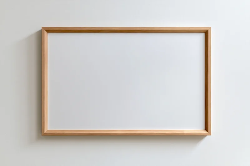 Thin light natural wood rectangular picture frame hanging on white wall with blank white interior