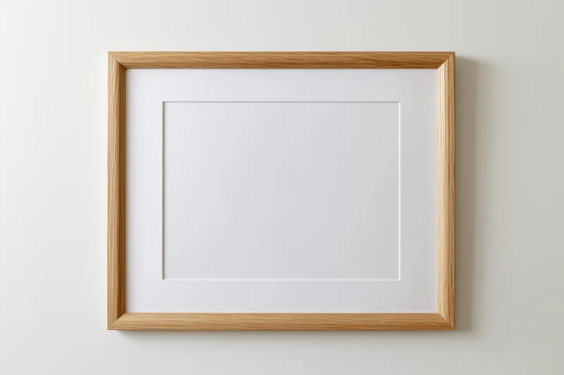 Light oak wooden frame with white mat hanging on a plain wall