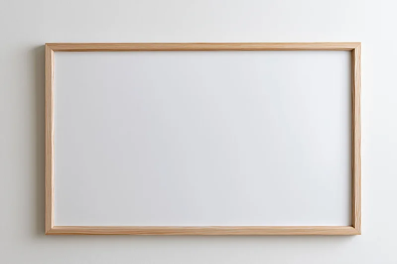 Light wood picture frame with blank white interior mount hanging on a white wall