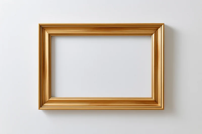 Gold rectangular picture frame hanging on white wall