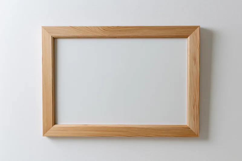 Wooden picture frame with empty white interior mounted on a plain wall