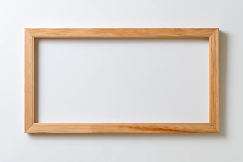 Wooden picture frame hanging on white wall with empty interior and clean minimalist design