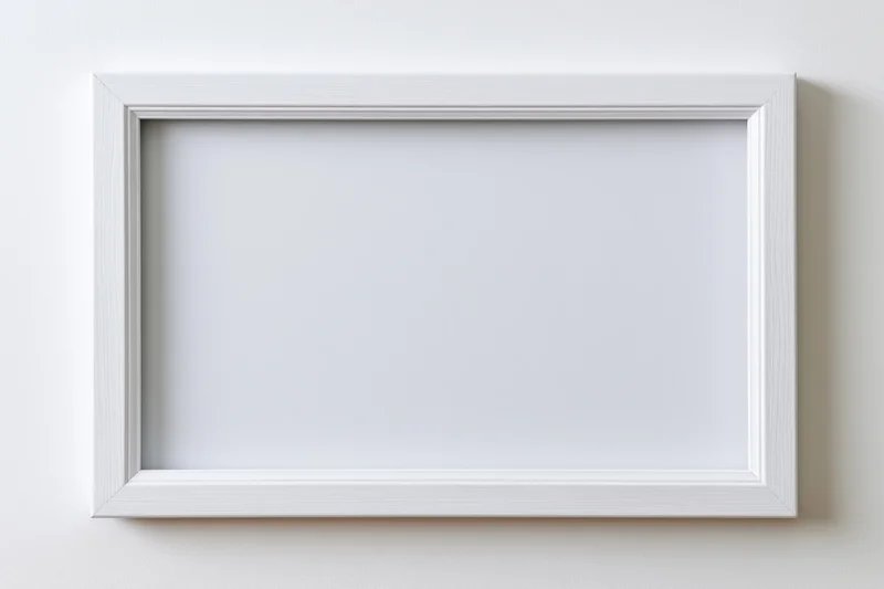 White rectangular frame with empty interior mounted on a plain wall