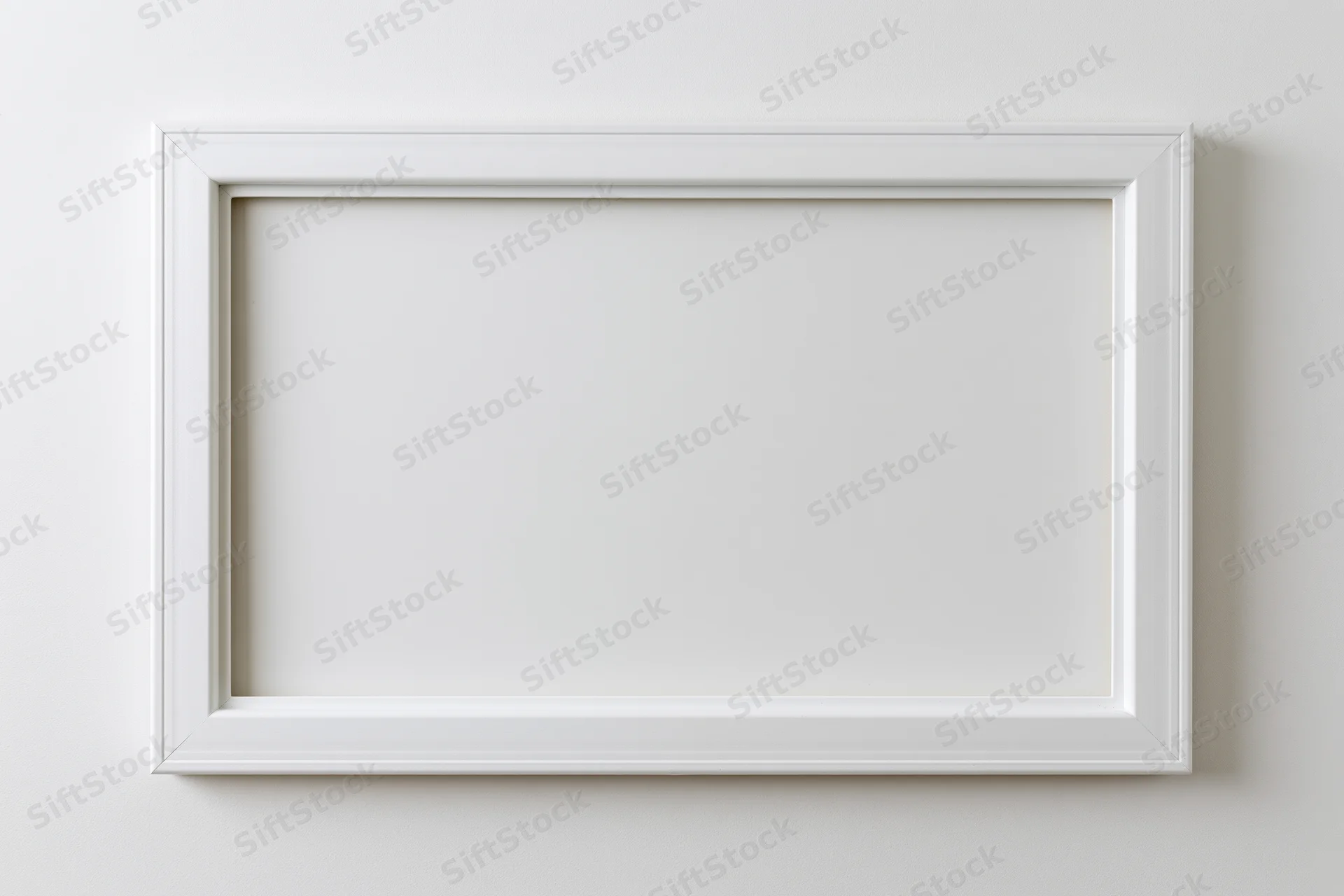 White rectangular frame with empty interior mounted on a plain wall
