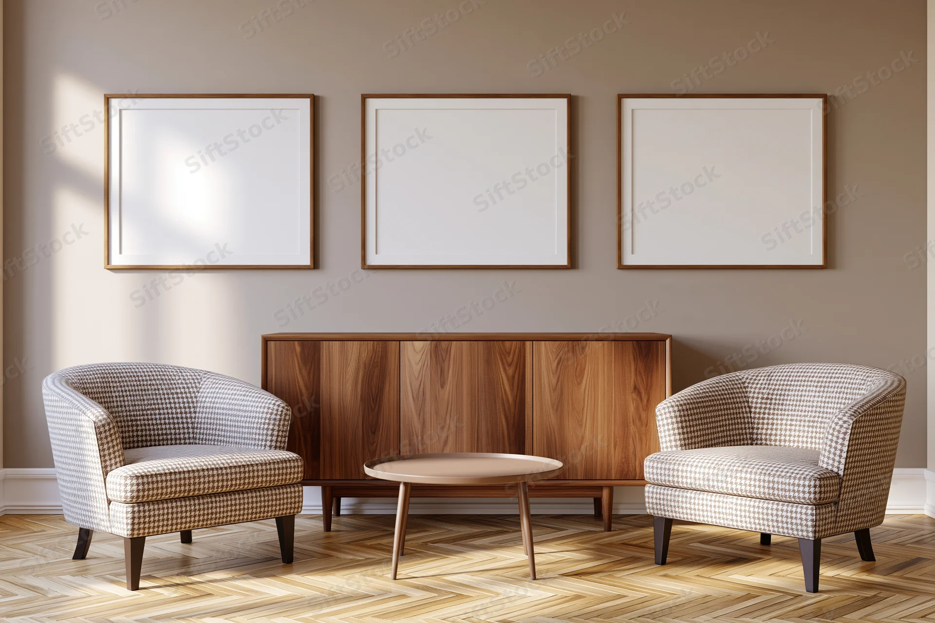 Two houndstooth armchairs flanking a wooden cabinet with a round coffee table beneath three blank framed pictures on a beige wall