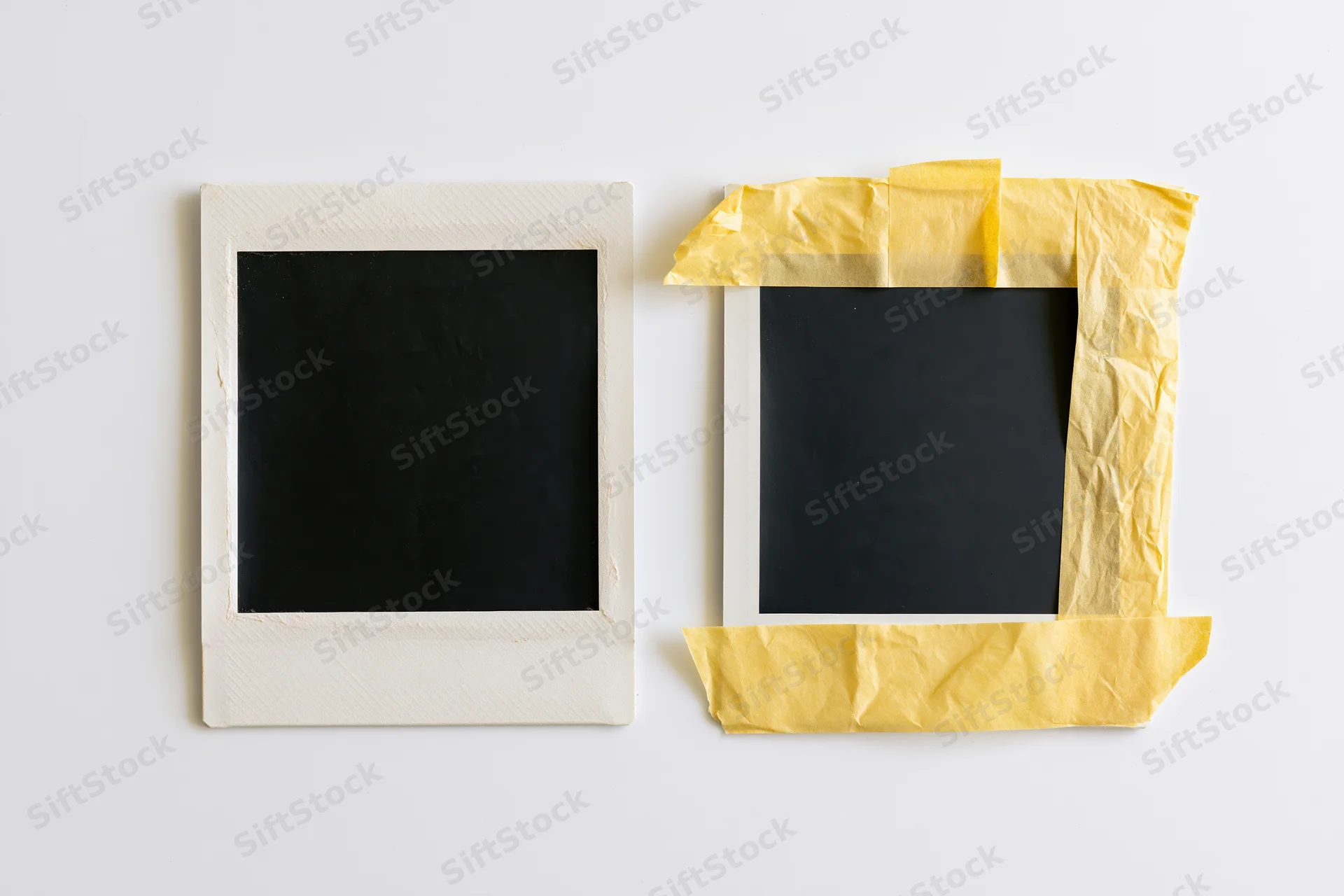 Two blank instant film photo prints side by side on white background, one with yellow tape border