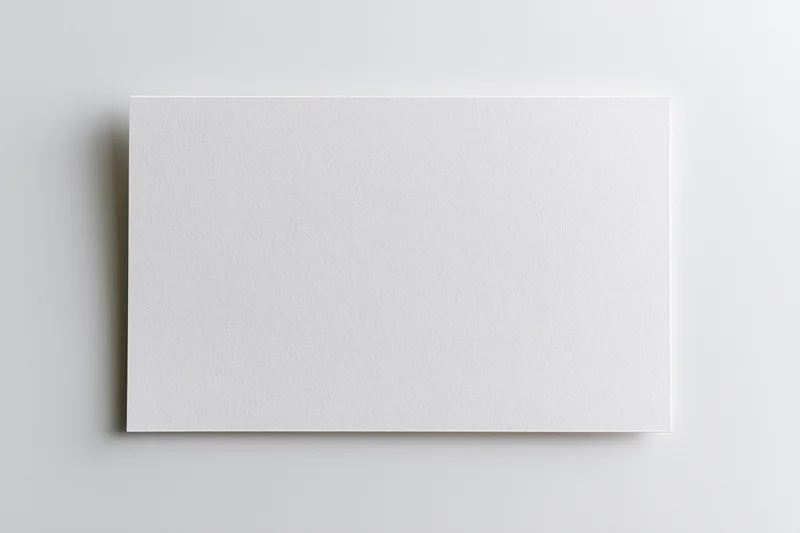 Blank white rectangular card lying flat on a neutral surface