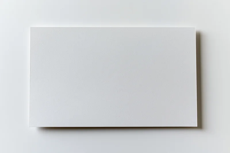 Blank white rectangular card lying flat on a plain surface