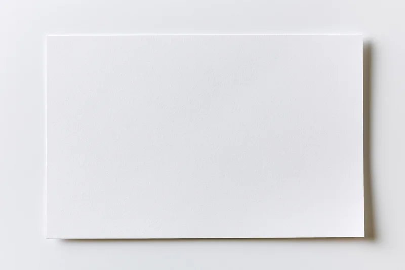 Blank white rectangular card lying flat on a light surface