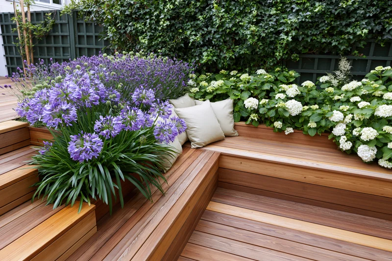 Built-in hardwood bench with purple and white flowers in a compact urban garden terrace