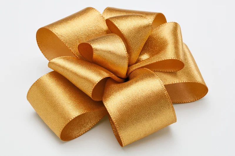 Gold satin ribbon bow with multiple loops on white background