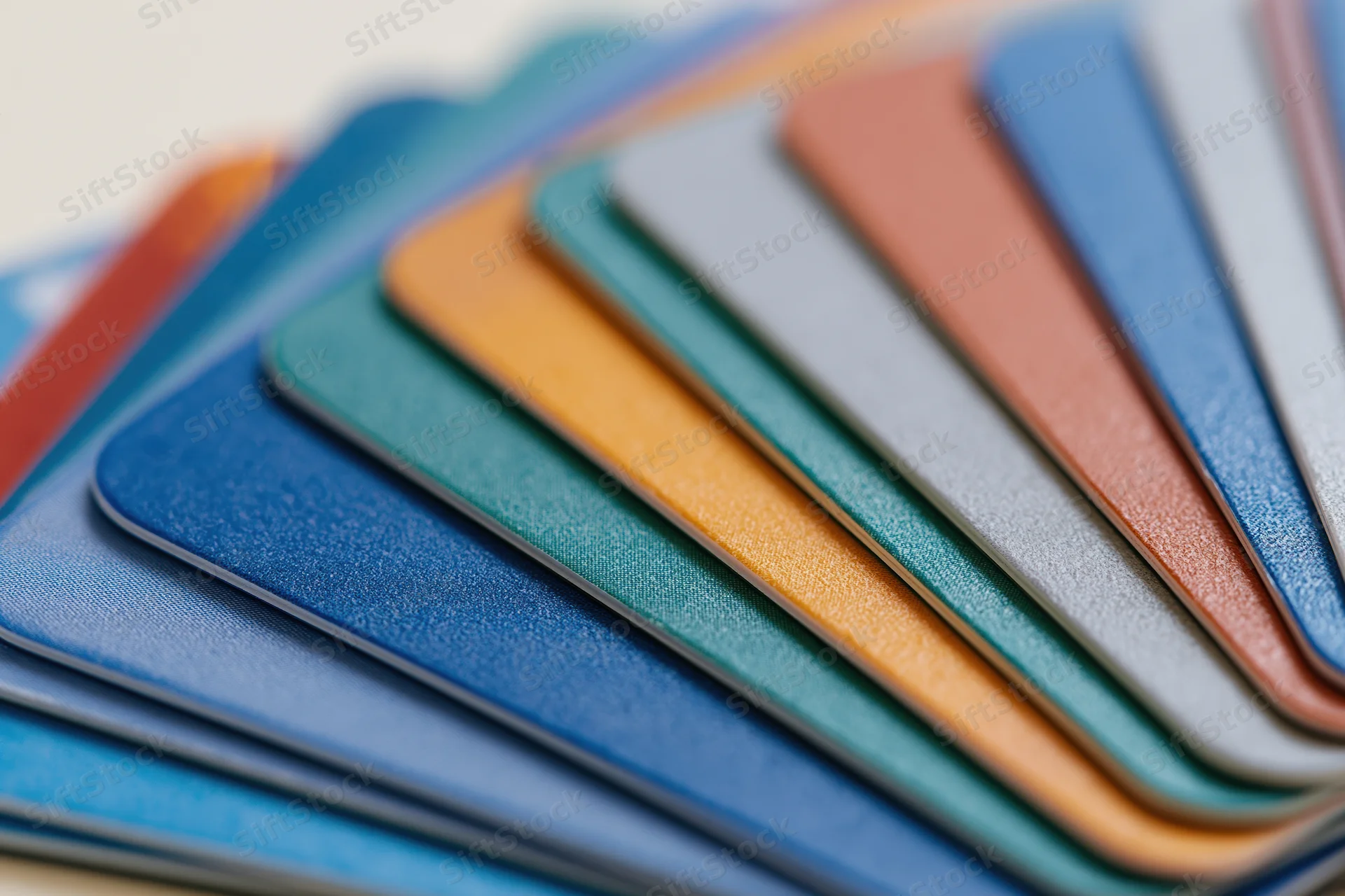 Fanned stack of colorful plastic cards arranged in overlapping layers for color selection