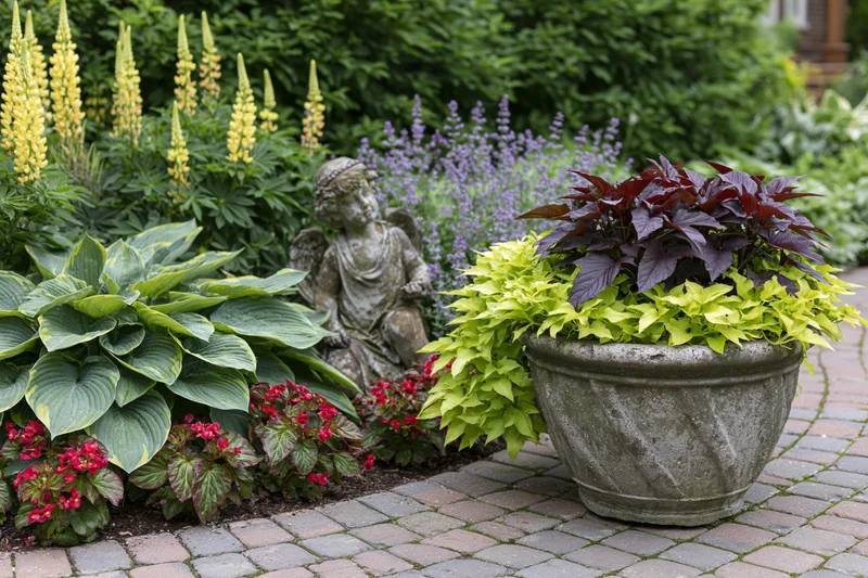 Lush garden border with hosta, lupine, and a stone angel statue beside a potted plant on a brick pathway