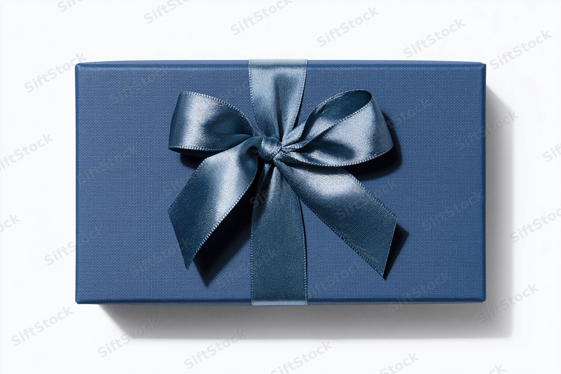 Navy gift box with satin ribbon bow on white background