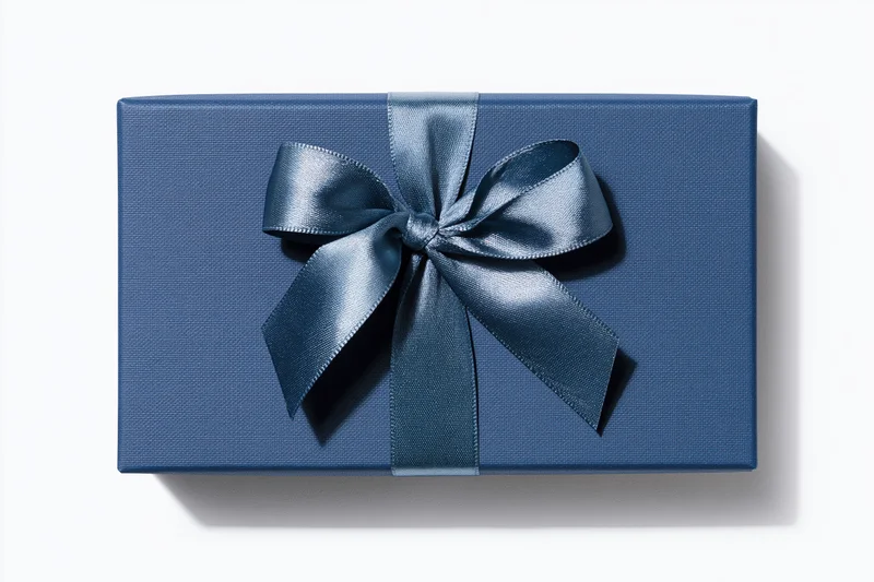 Navy gift box with satin ribbon bow on white background