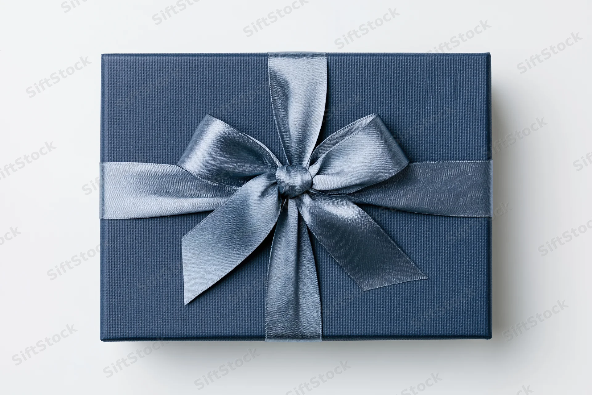 Navy gift box with satin ribbon bow on white background