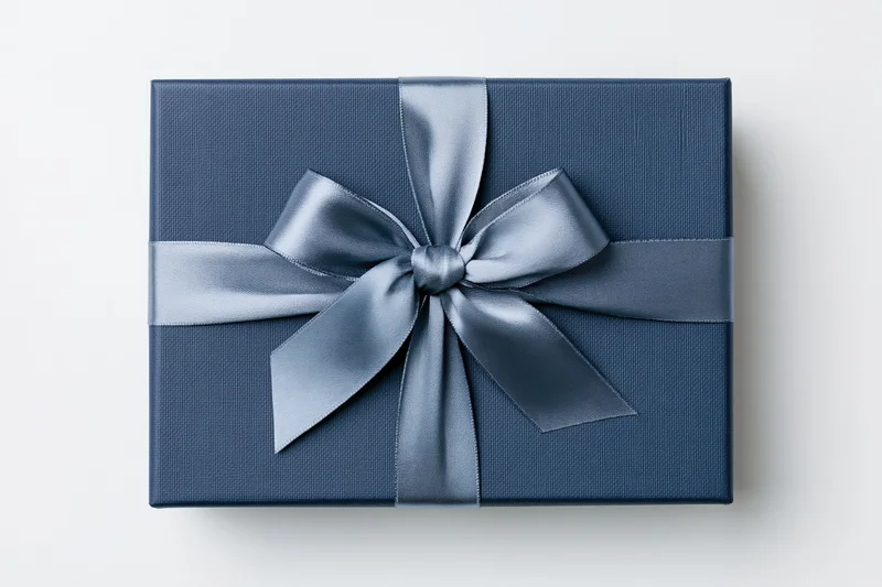 Navy gift box with satin ribbon bow on white background