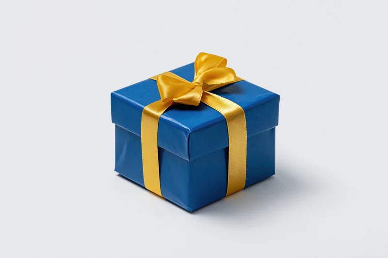 Blue gift box wrapped with yellow ribbon on white background