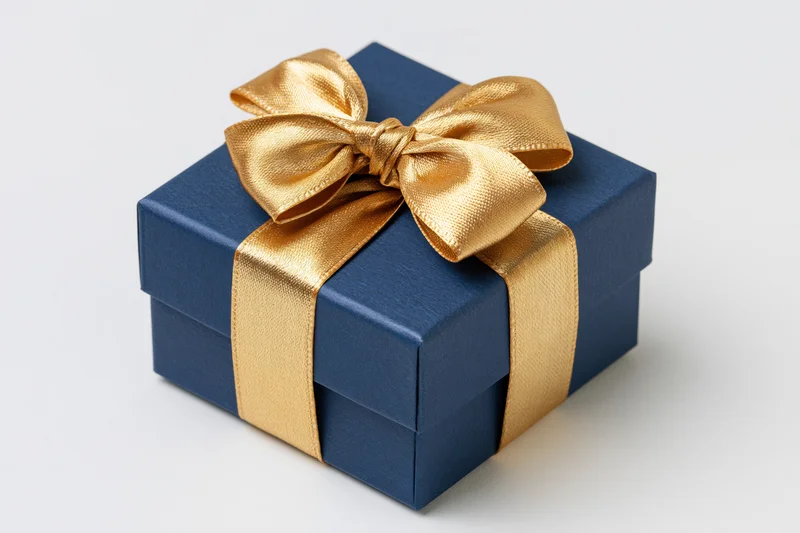 Navy gift box with gold satin ribbon bow on white background