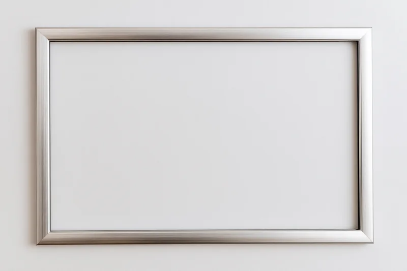 Silver metallic picture frame hanging on a white wall with blank interior