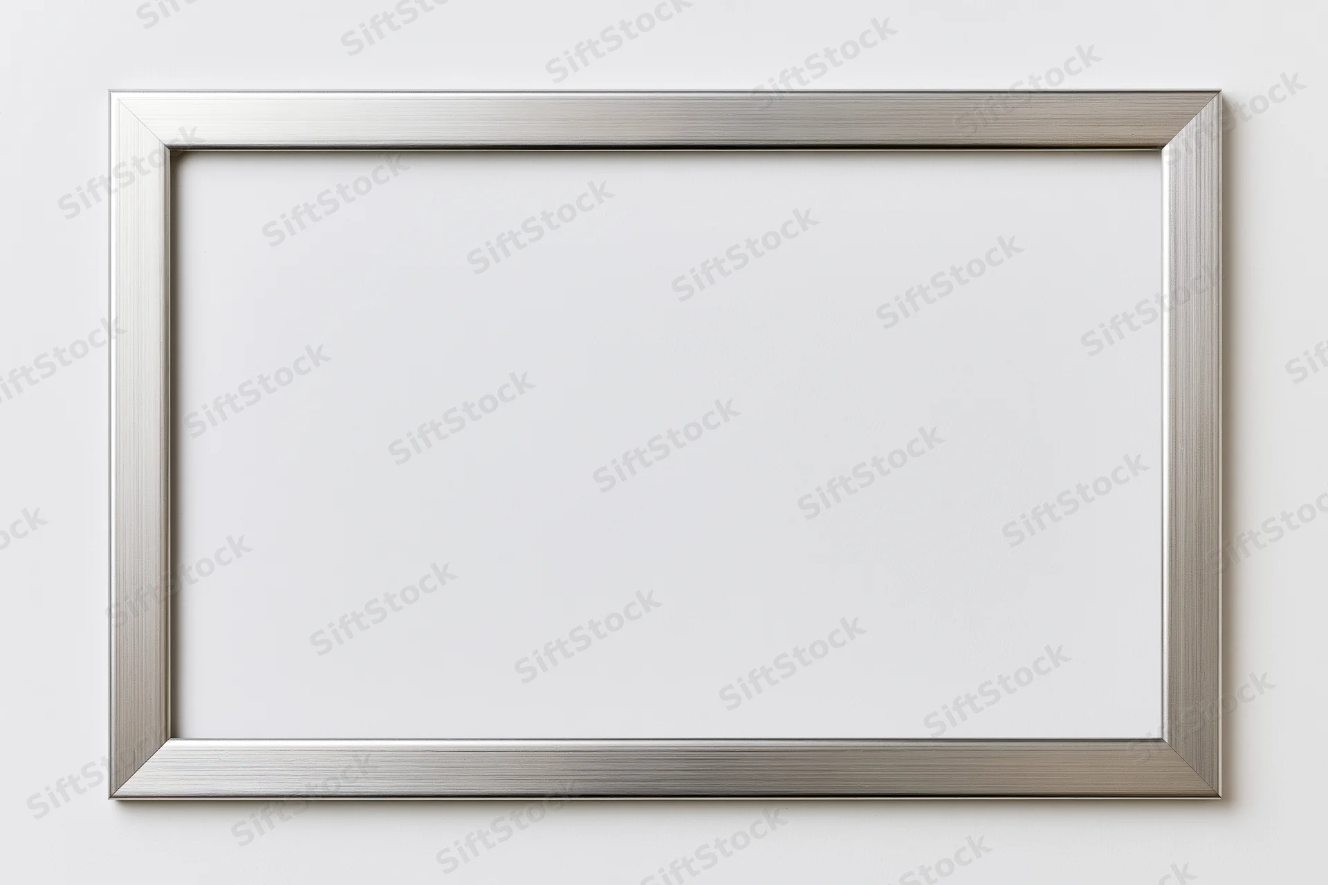 Silver metallic picture frame mounted on white wall with blank interior
