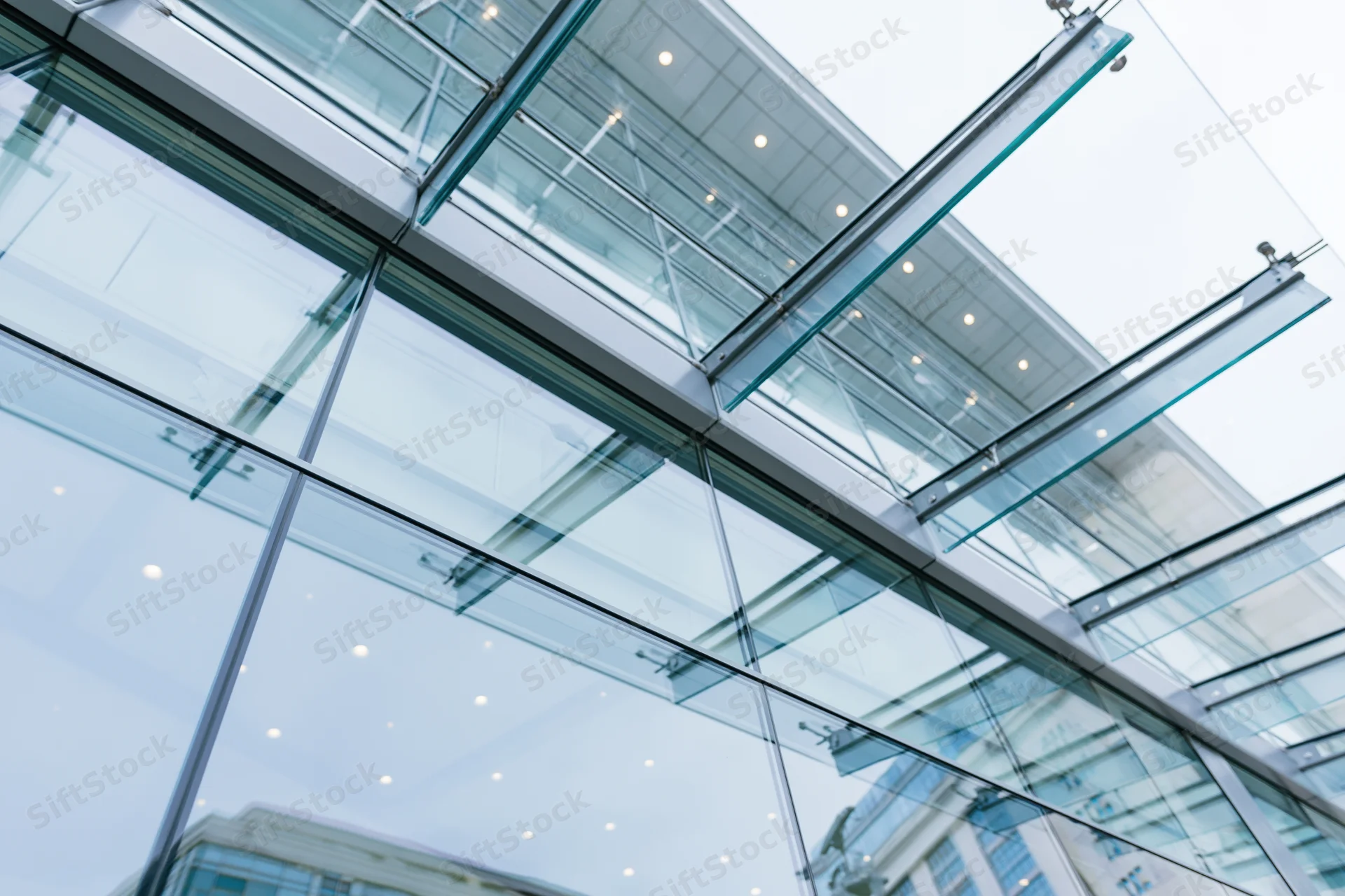Upward view of a modern glass curtain wall on a corporate building exterior