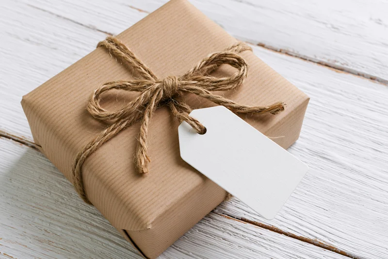 Brown kraft paper wrapped gift box tied with natural twine