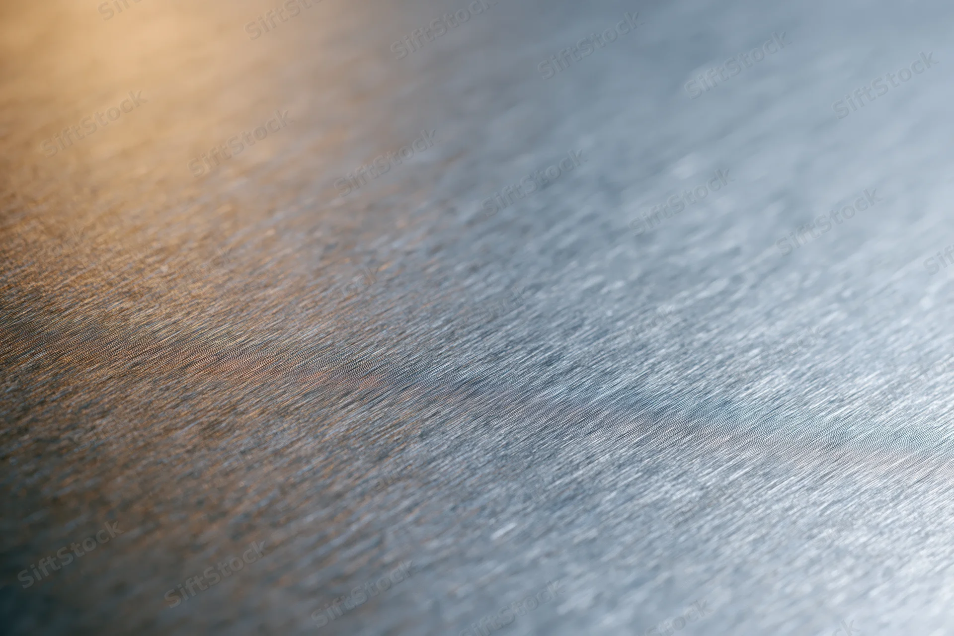 Close-up of brushed metal surface with soft reflected light gradient
