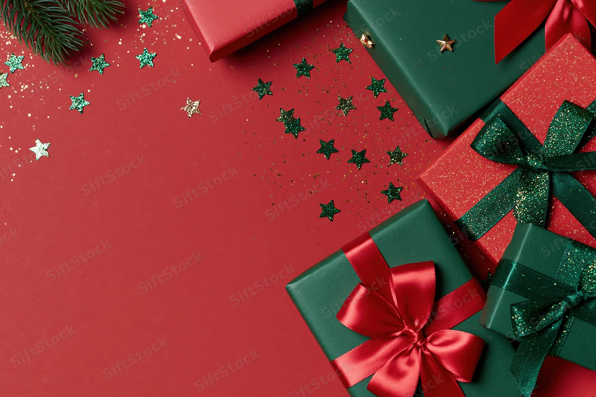Christmas gift boxes wrapped in red and green paper with ribbons and stars on a red surface