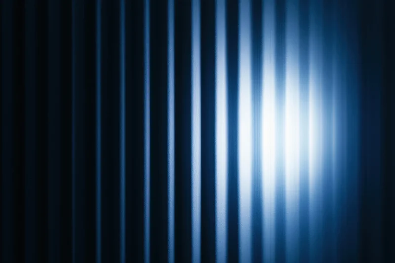 Vertical ridged panels with blue light gradient and metallic texture