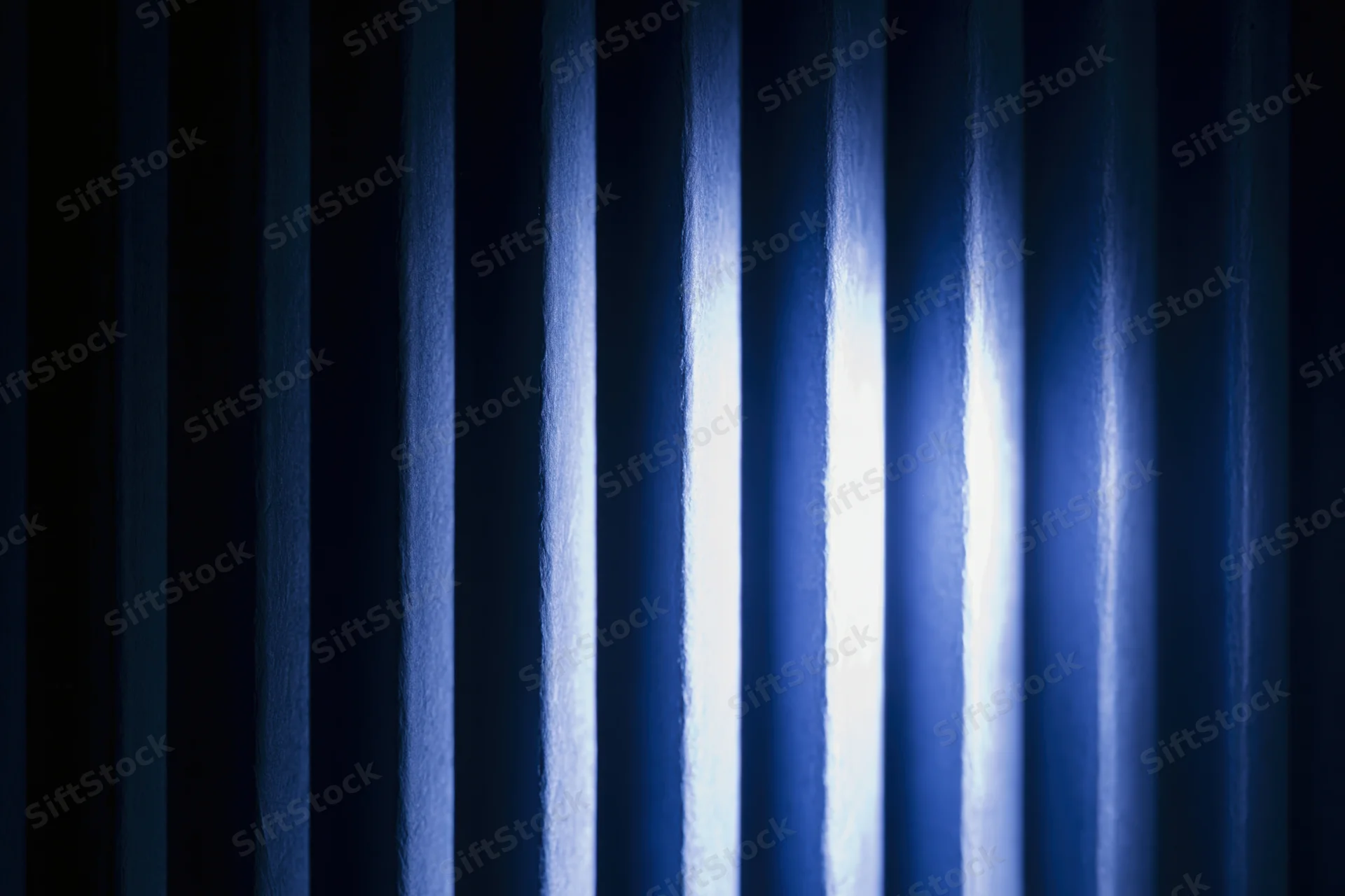 Vertical ridged panels with light and shadow creating abstract striped texture