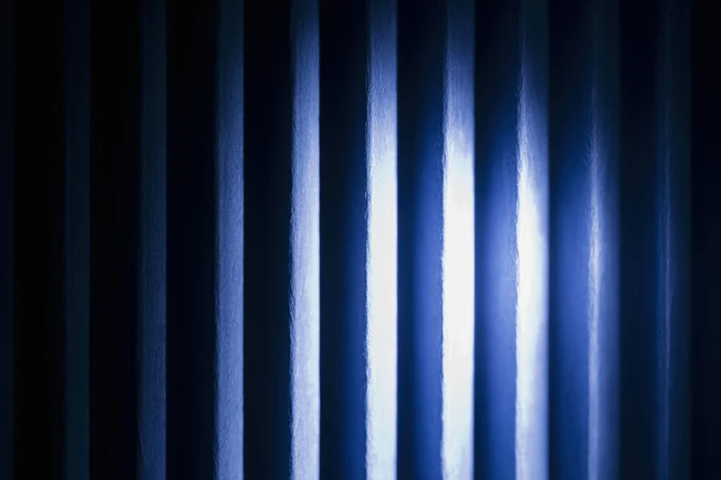 Vertical ridged panels with light and shadow creating abstract striped texture