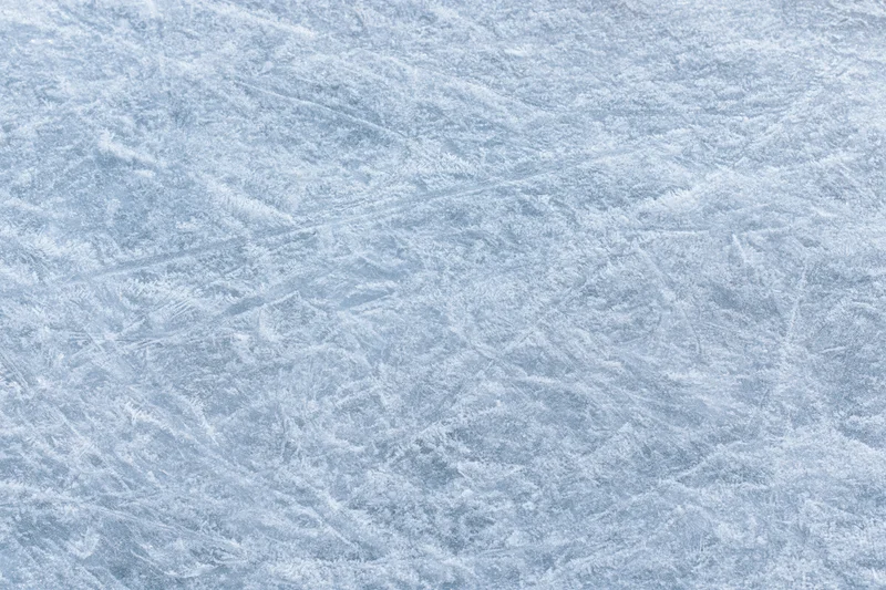 Close-up of a frozen ice surface with natural frost patterns and crystalline texture