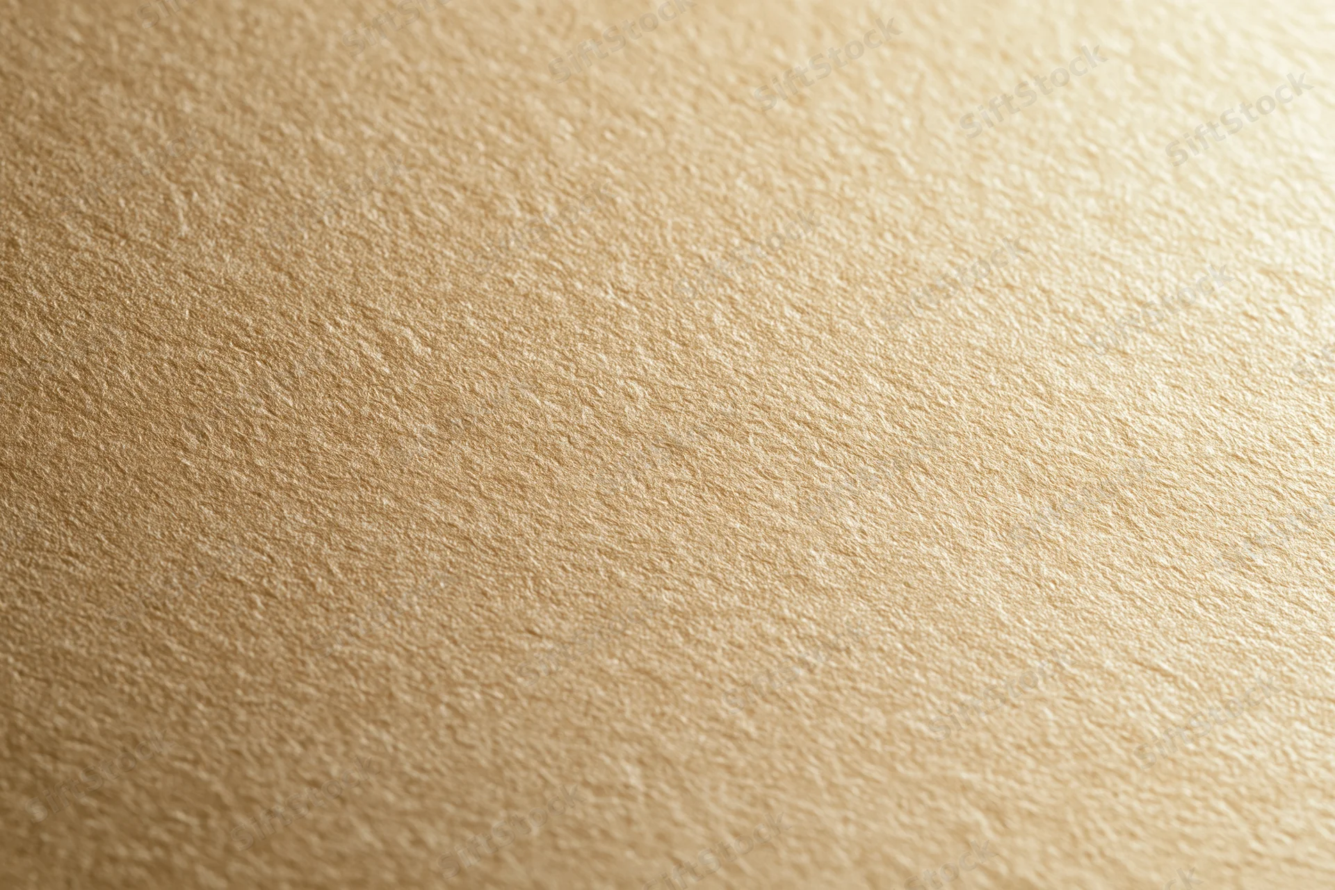 Close-up of a matte gold textured surface filling the frame