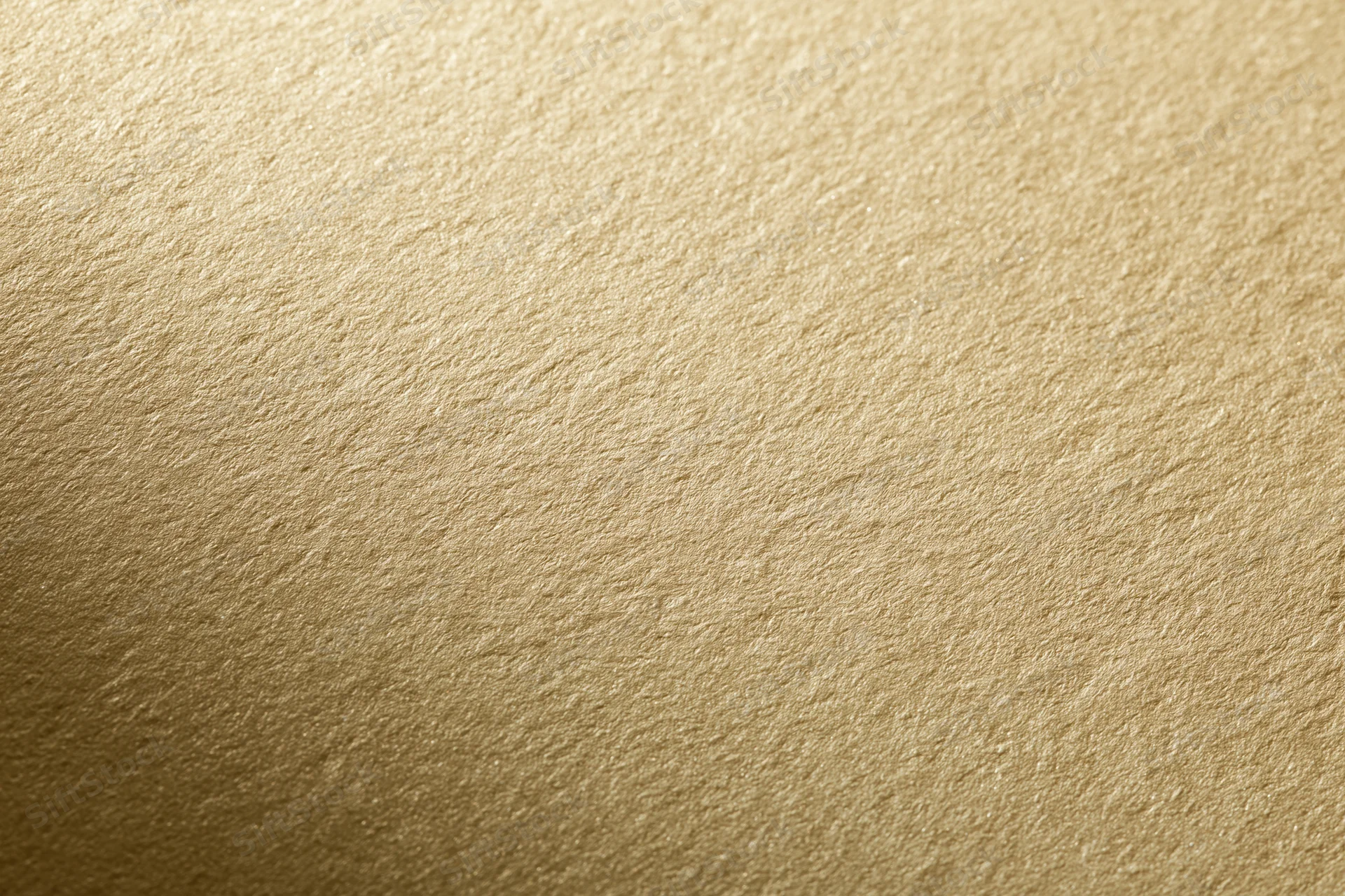 Close-up of a matte gold textured surface filling the frame