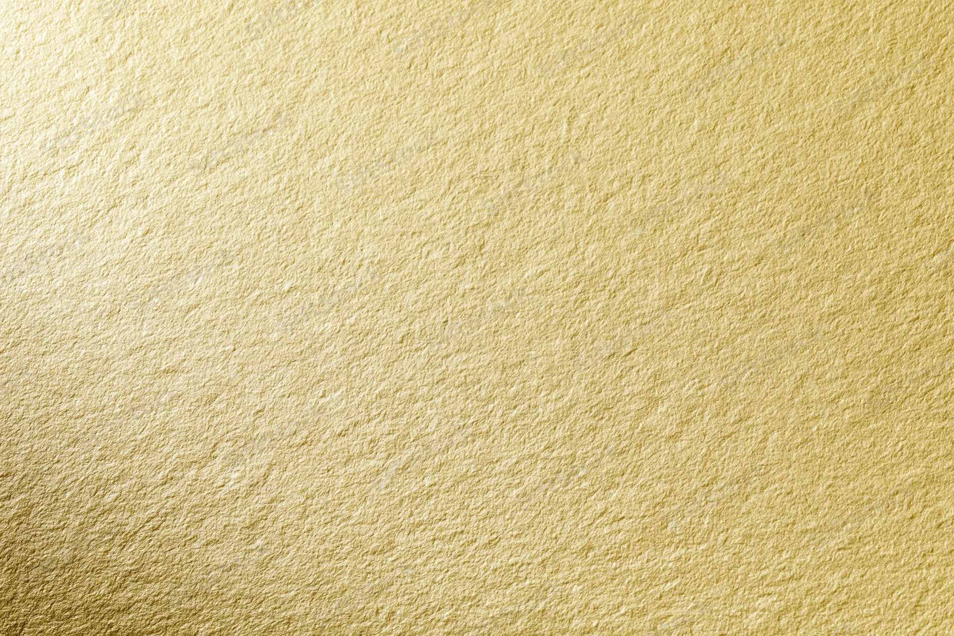 Close-up of a matte gold textured surface filling the frame