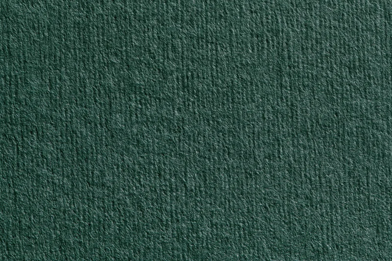 Close-up of dark forest green ribbed fabric texture filling the frame