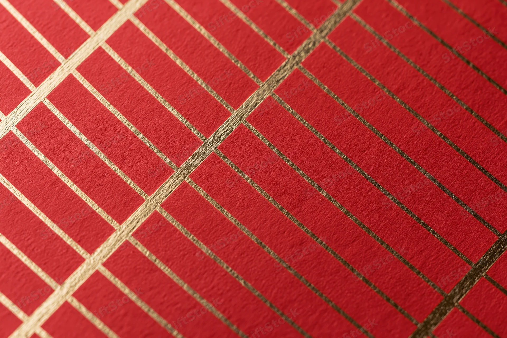 Close-up of red wrapping paper with gold grid pattern for gift decoration