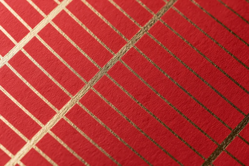 Close-up of red wrapping paper with gold grid pattern for gift decoration