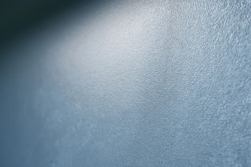 Close-up of frosted glass surface with fine texture and soft light gradient