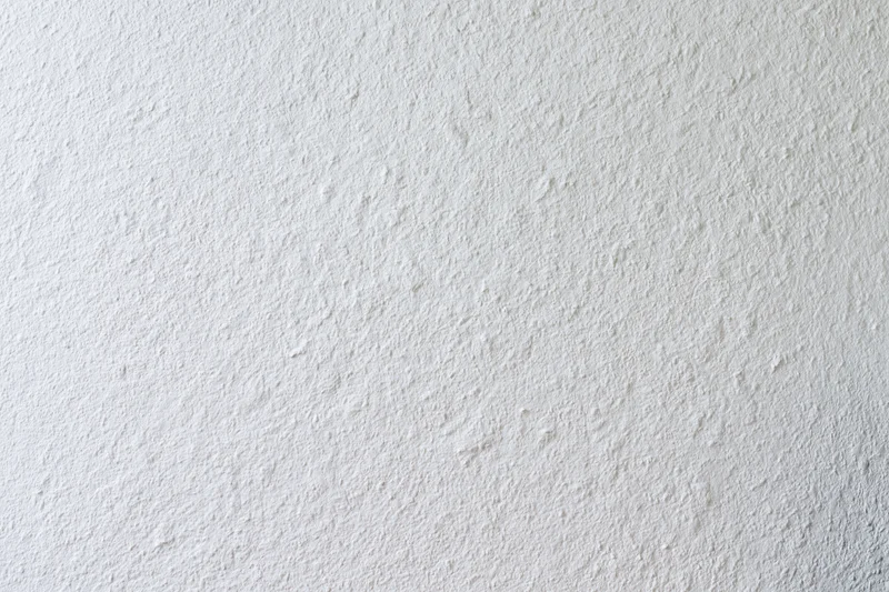 Close-up of a plain white painted wall surface with textured finish