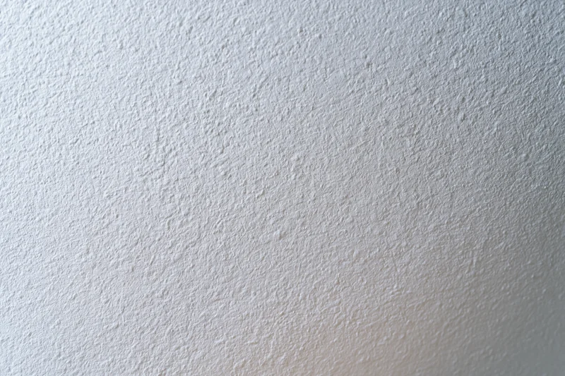 Close-up of a plain white painted wall surface with textured finish