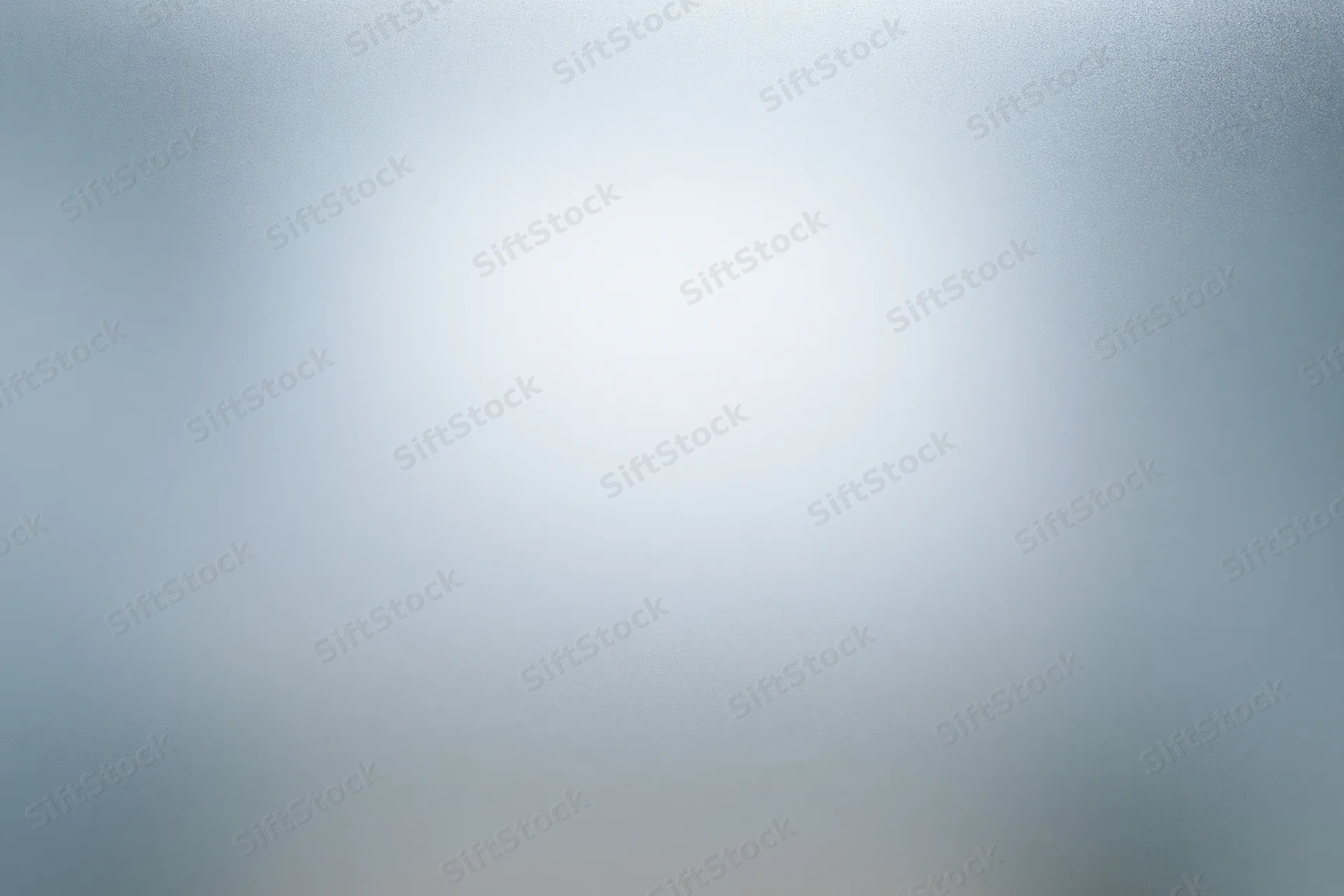 Close-up of frosted glass surface with soft light gradient and diffuse texture
