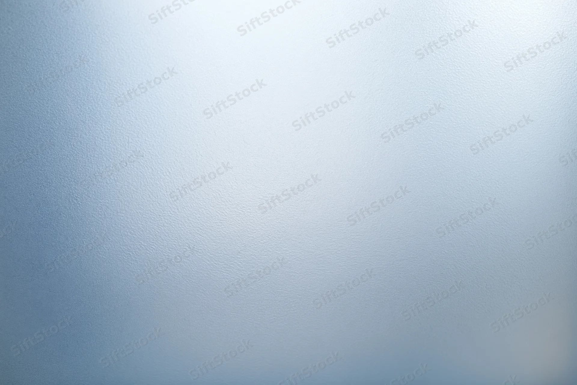 Frosted glass surface with smooth texture and soft light gradient filling the frame