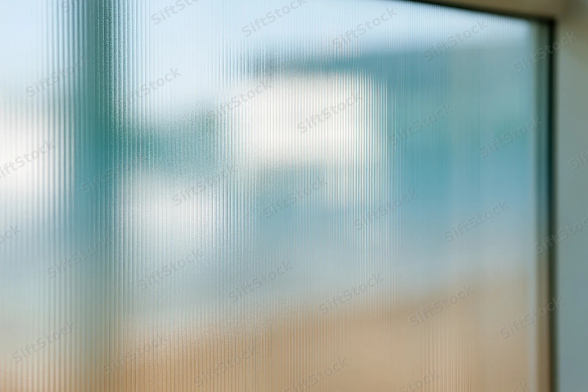 Close-up of ribbed translucent glass panel with vertical lines and diffused light, framed edge visible