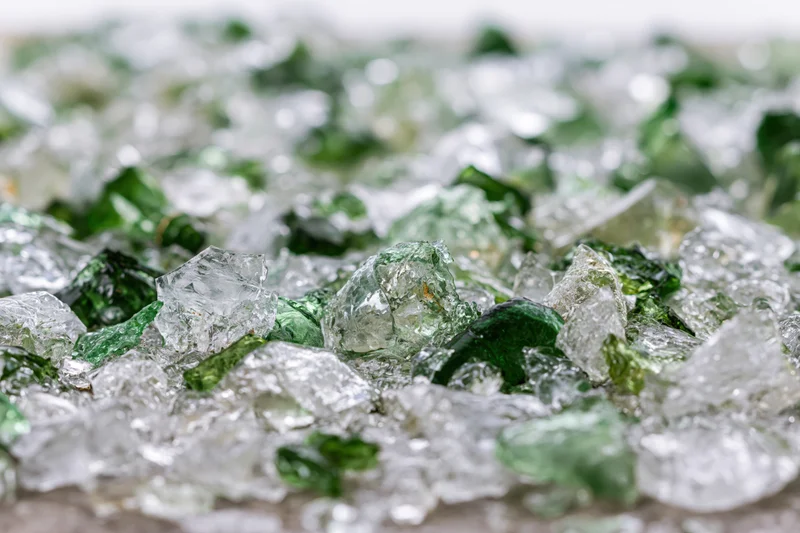 Crushed glass shards scattered densely on a flat surface