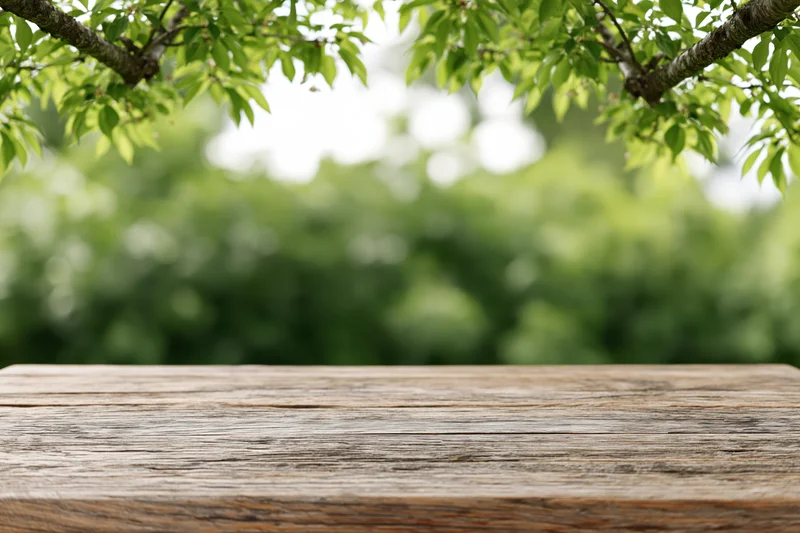 Weathered wooden tabletop in a lush green garden setting