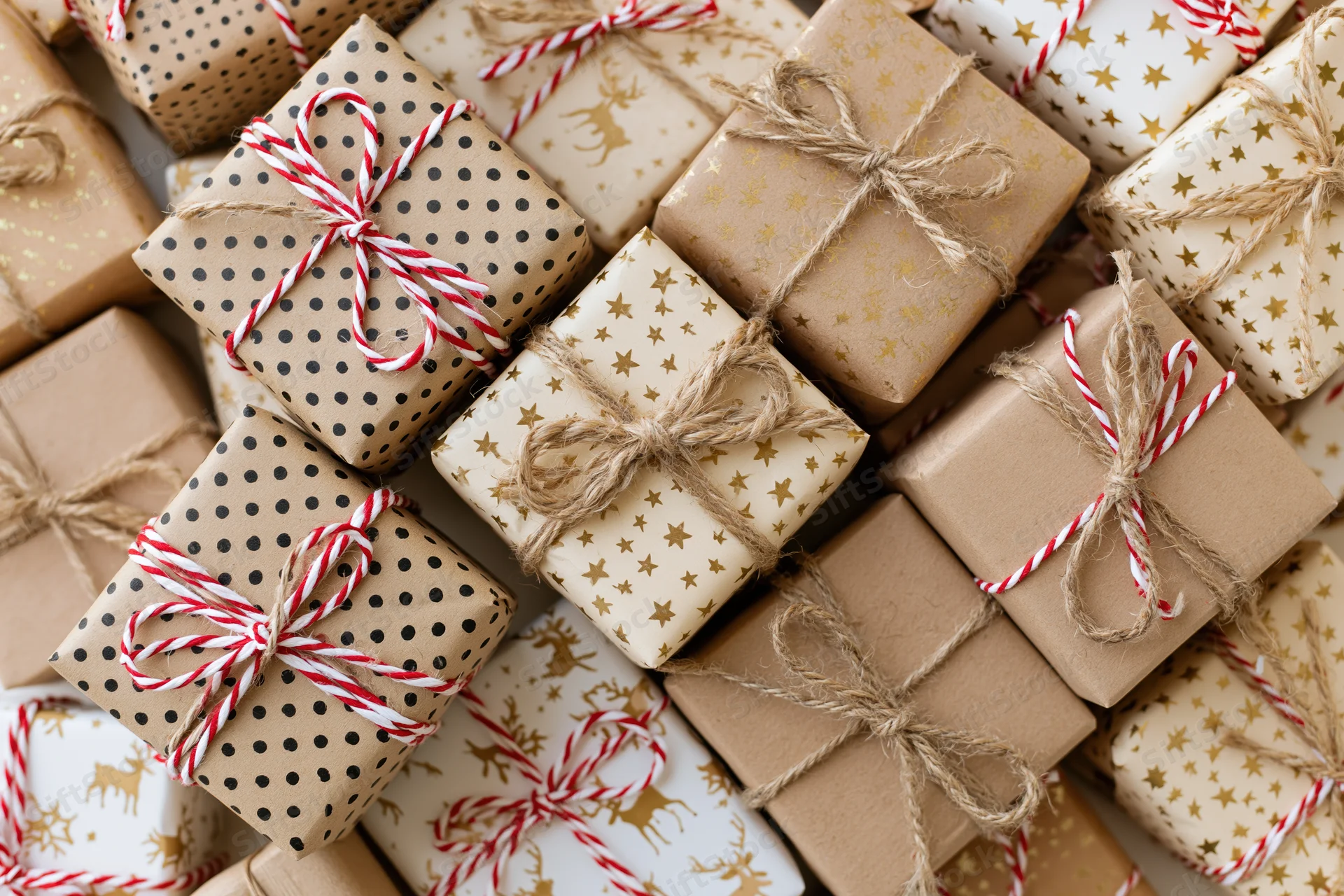 Many wrapped gift boxes arranged tightly in a flat lay overhead view