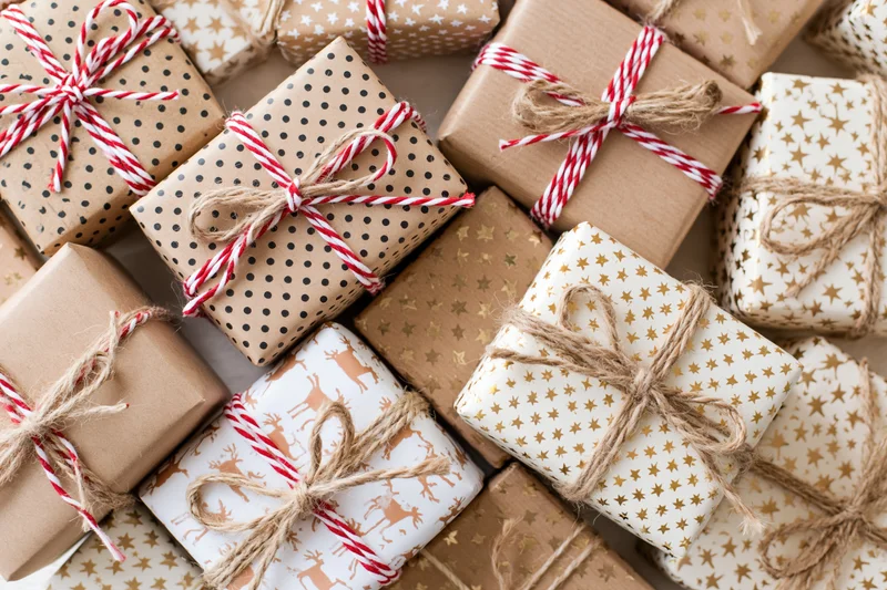 Many wrapped gift boxes arranged tightly in a flat lay overhead view
