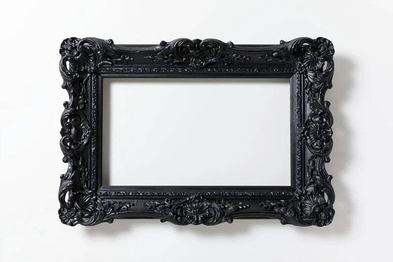 Ornate black baroque picture frame with intricate carvings displayed flat against a white background